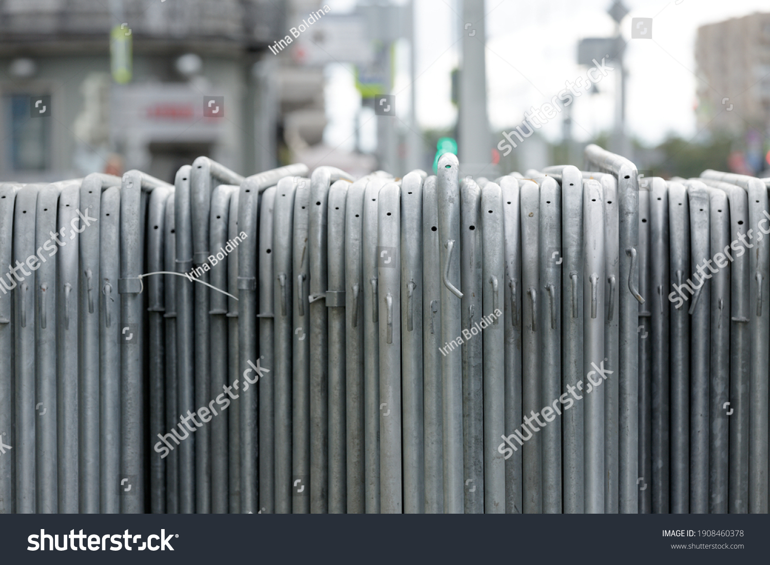 Temporary fence. Metal sections of temporary fencing, portable pedestrian barrier assembled and stand in a row #1908460378