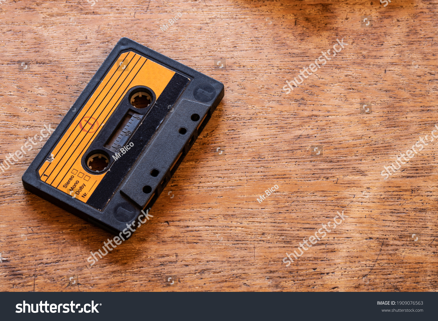 Old cassette tape on a wood table #1909076563