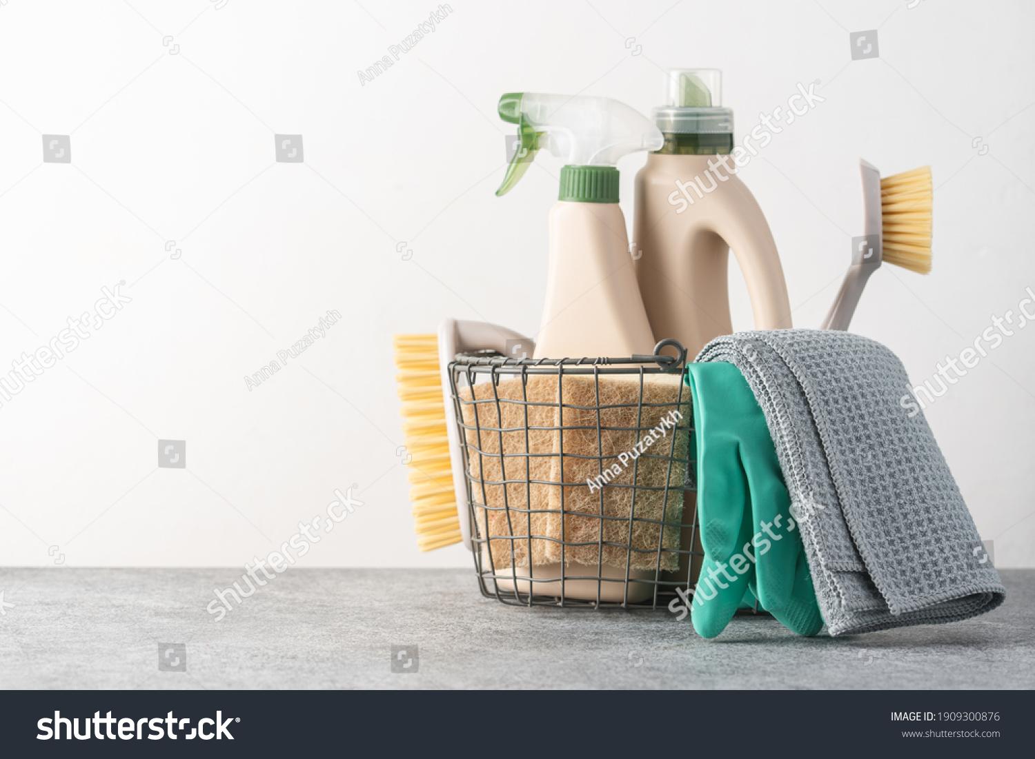 Brushes, sponges, rubber gloves and natural cleaning products in the basket.  Eco-friendly cleaning products #1909300876