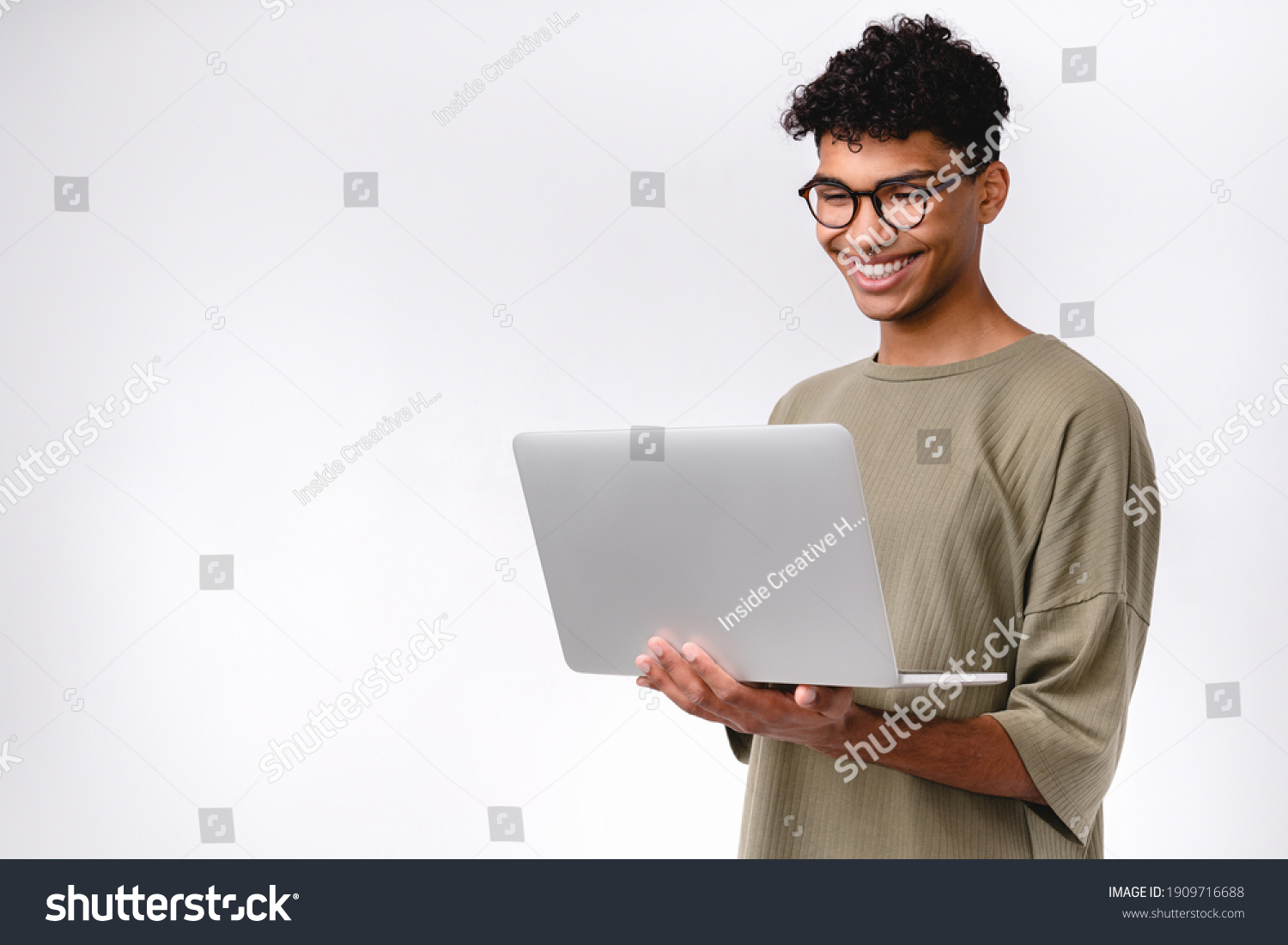 Smart young mixed-race student using laptop isolated over white background #1909716688