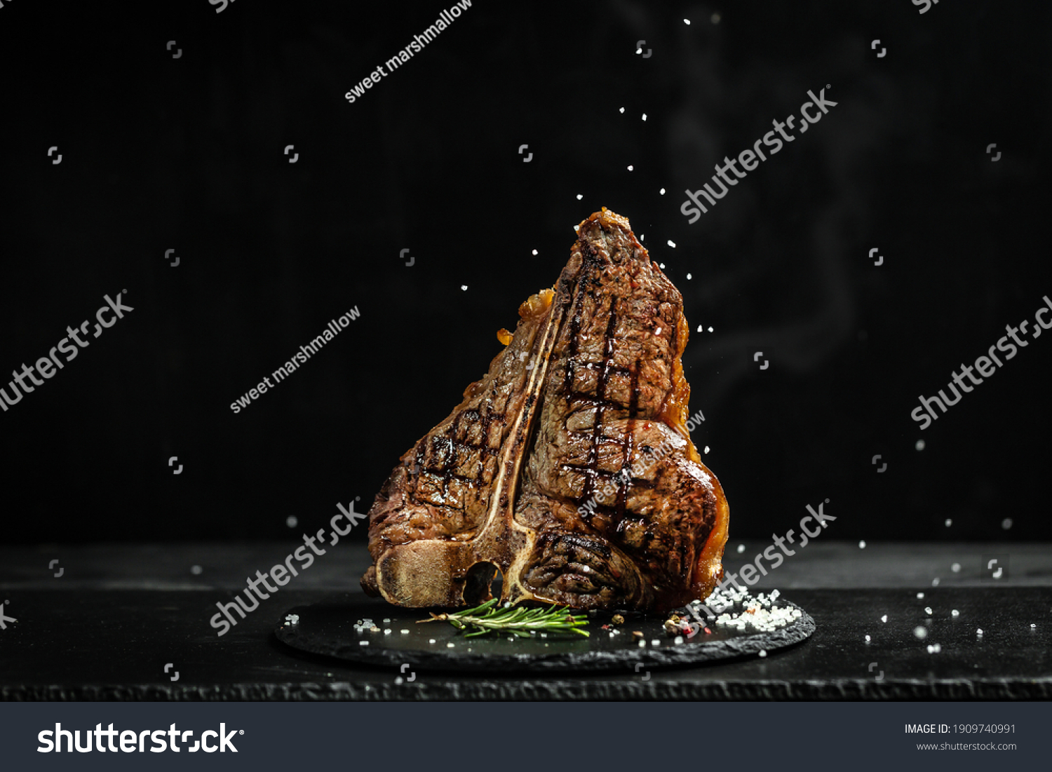 The T-bone or porterhouse steak of beef cut from the short loin. steaksT-shaped bone with meat on each side. banner, catering menu recipe place for text. #1909740991