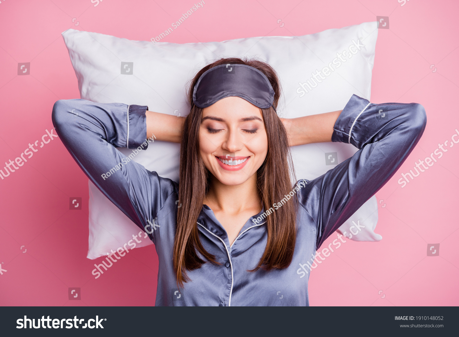Photo portrait of pretty brunette wearing pajama relaxing after hard day laying on pillow isolated on pastel pink color background #1910148052