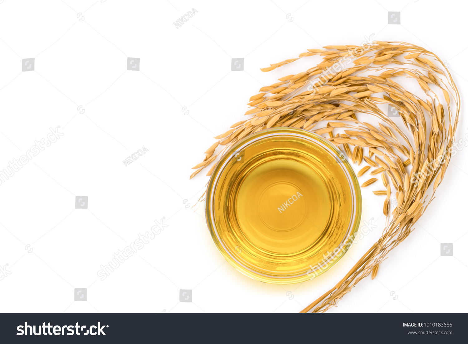 Rice bran oil extract with paddy unmilled rice on white background. Top view. Flat lay. #1910183686