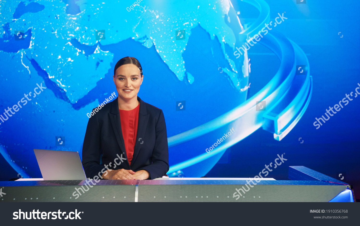 Live News Studio with Professional Female Newscaster Reporting on the Events of the Day. Broadcasting Channel with Presenter, Anchor Smiling on Camera. Mock-up TV Newsroom Set. #1910356768