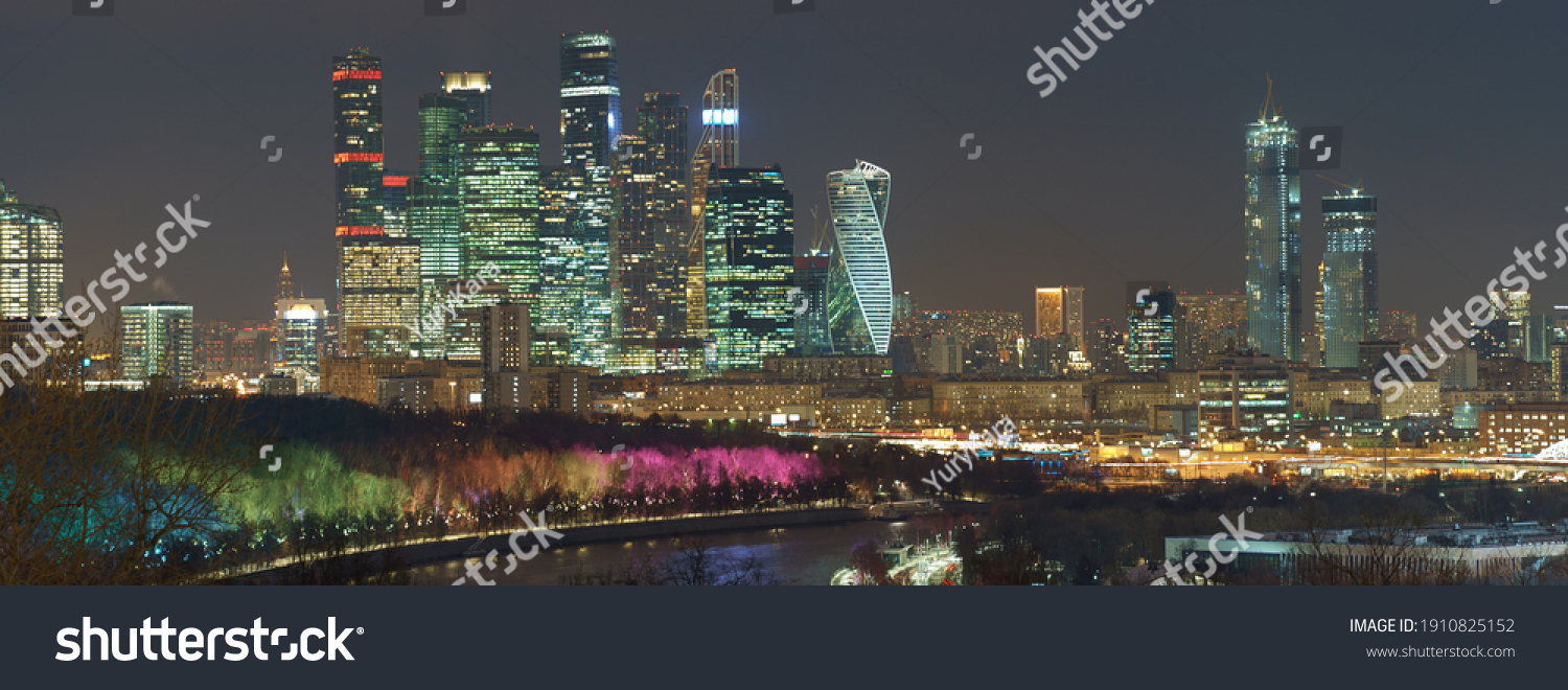 Long exposure photography of Moscow cityscape during winter night. Cold weather. Blurred lights of the city. Bright lighting of Moskva river embankment. Skyscrapers of Moscow business district #1910825152