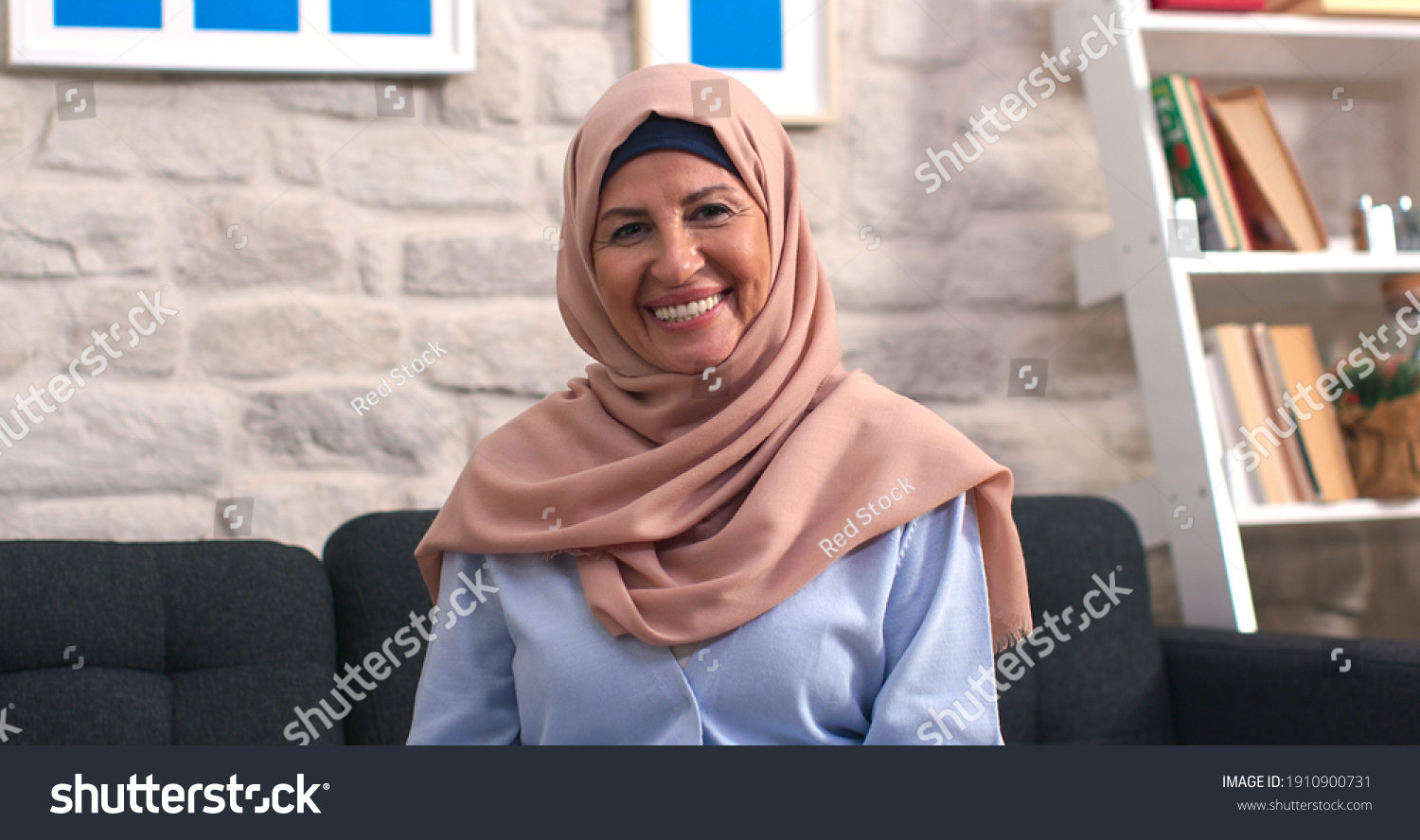 Beautiful face portrait of happy mature middle-aged woman in hijab. Old lady in turban looking at camera with healthy cheerful smile.  #1910900731