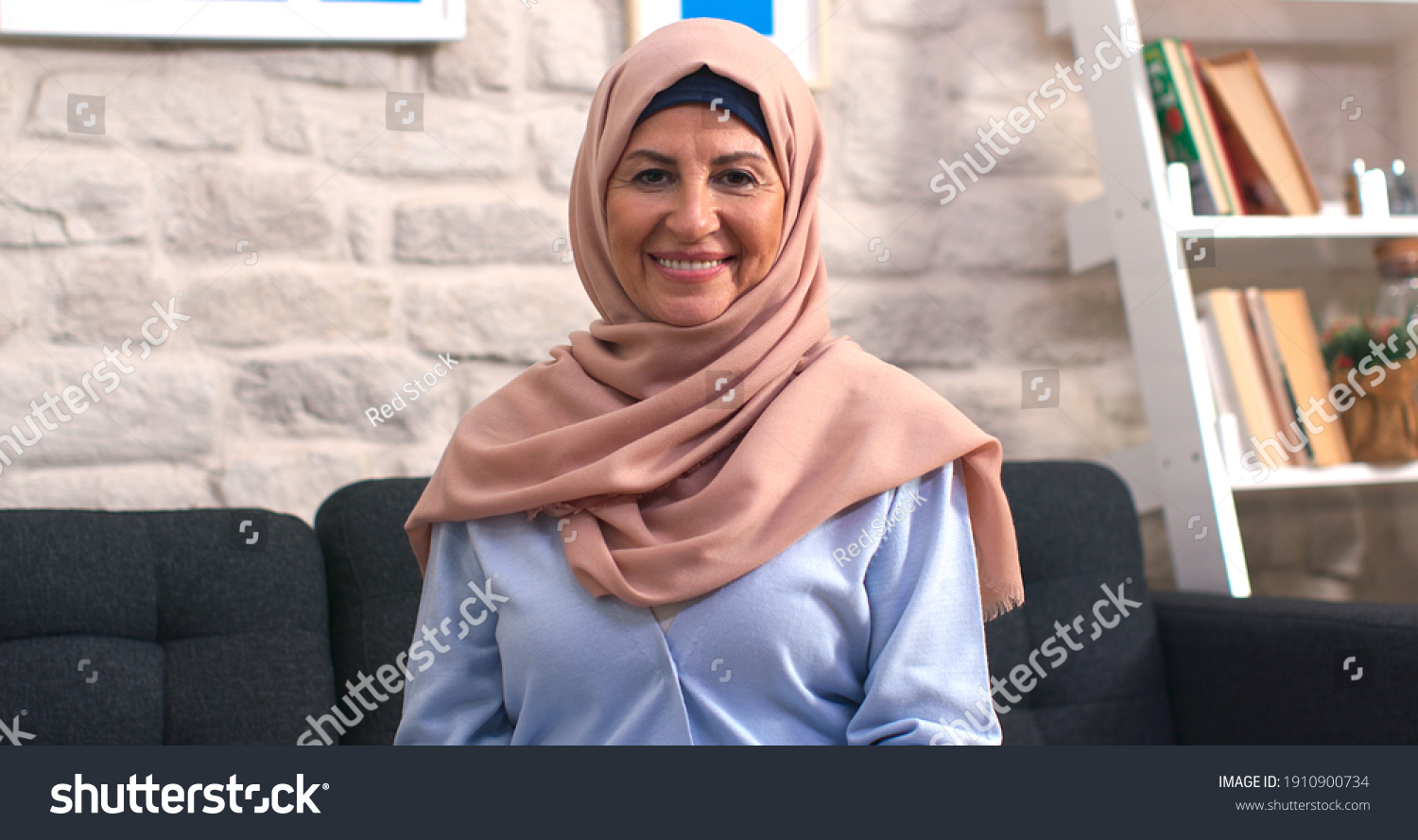 Beautiful face portrait of happy mature middle-aged woman in hijab. Old lady in turban looking at camera with healthy cheerful smile.  #1910900734