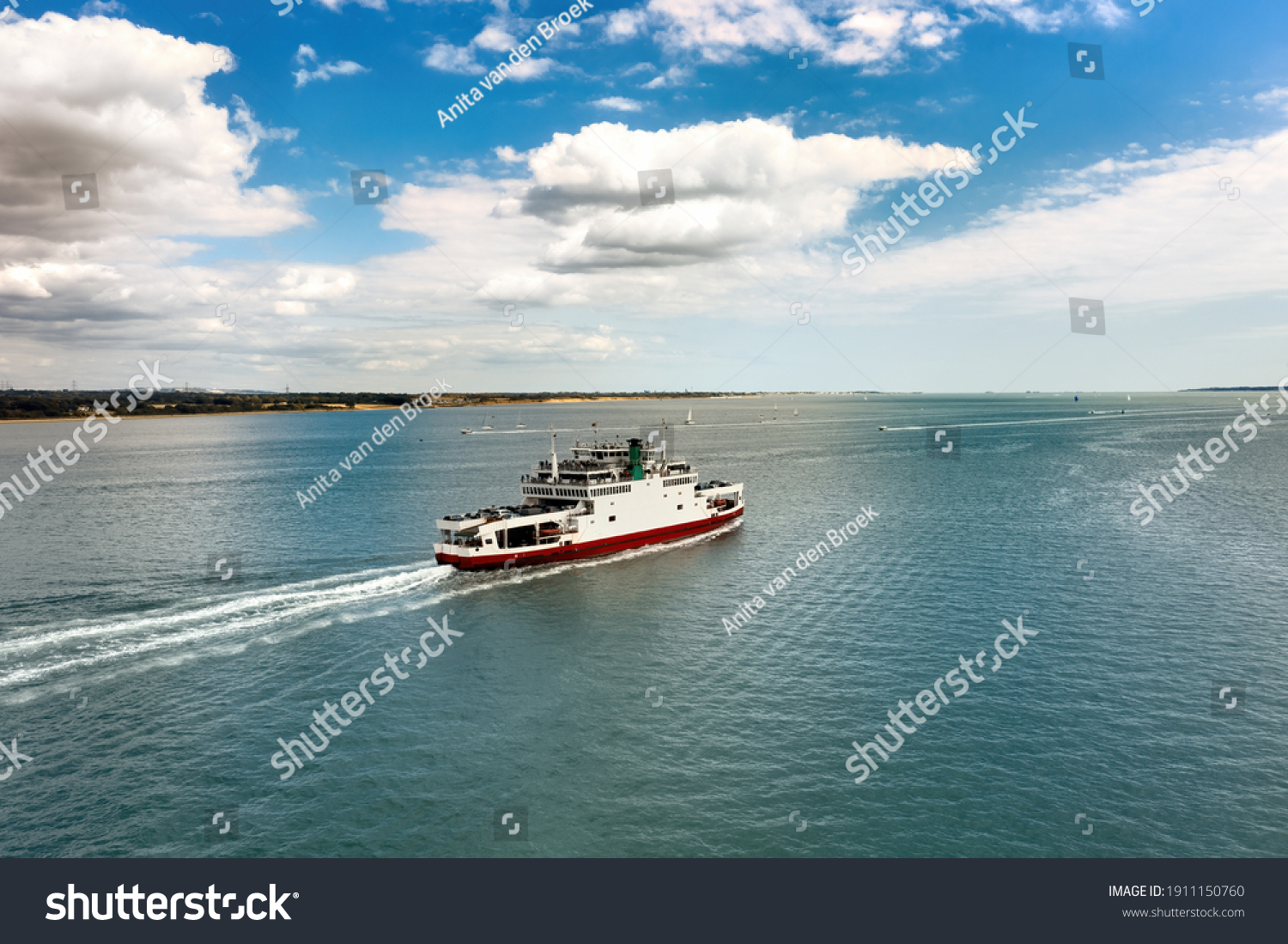 Car ferry in Southampton Water on a beautiful sunny day with clouds in the blue sky. Space for text. #1911150760