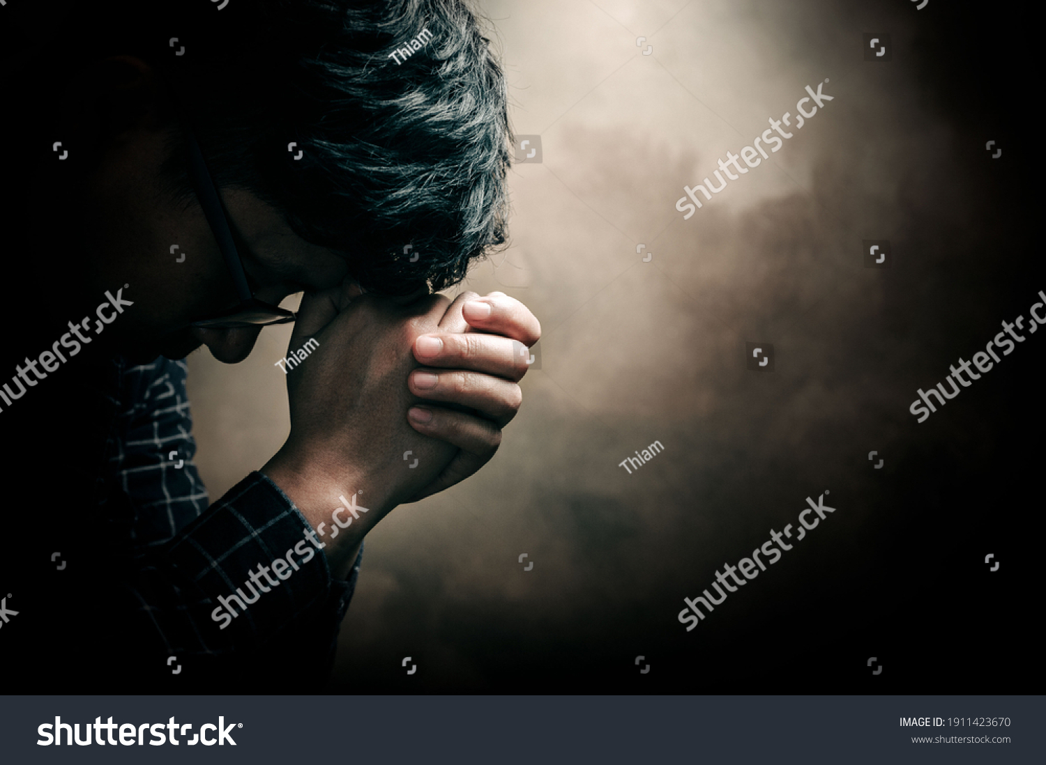 Christian life crisis prayer to god. Man Pray for god blessing to wishing have a better life. man hands praying to god with the bible. believe in goodness. Holding hands in prayer, eyes closed. #1911423670