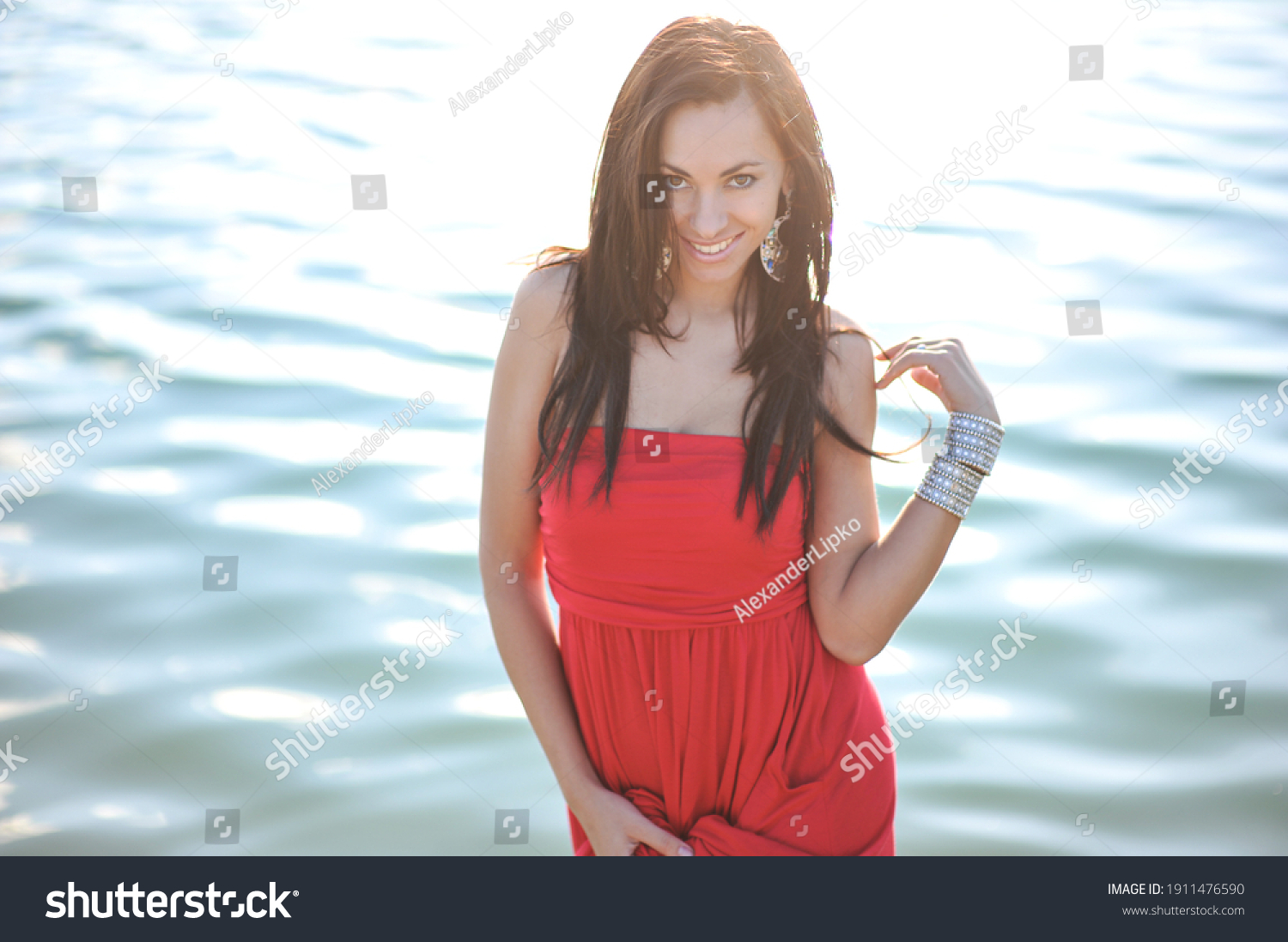 lifestyle photo of woman with perfect hair.walking alone at the beach.Sensual young girl relaxing.Colorful filter.glam style,teen trend outfit, positive mood,smiling,amazing model girl,long hair #1911476590