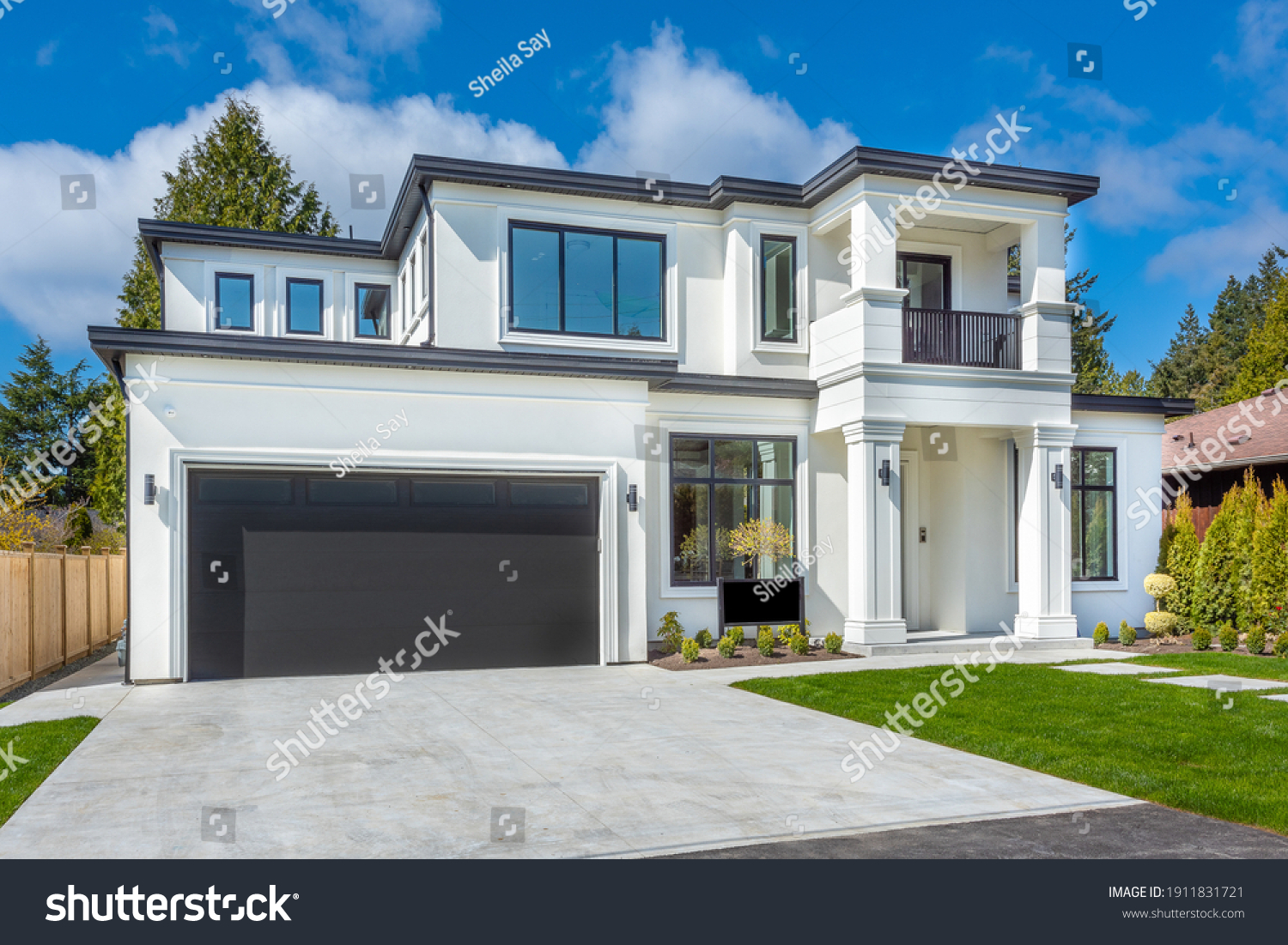 Beautiful contemporary white house with lush grass and blue sky twilight and daylight #1911831721