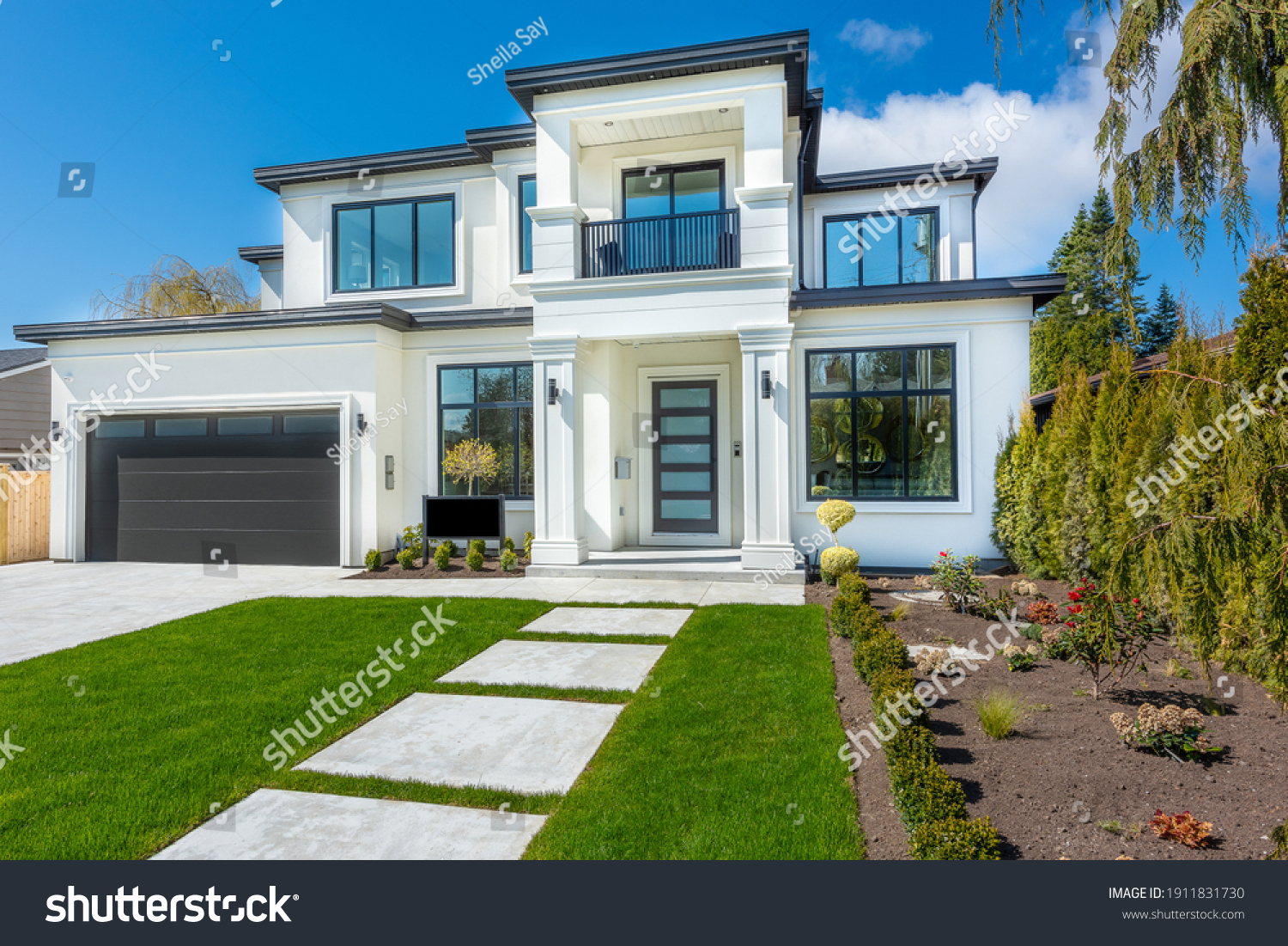 Beautiful contemporary white house with lush grass and blue sky twilight and daylight #1911831730