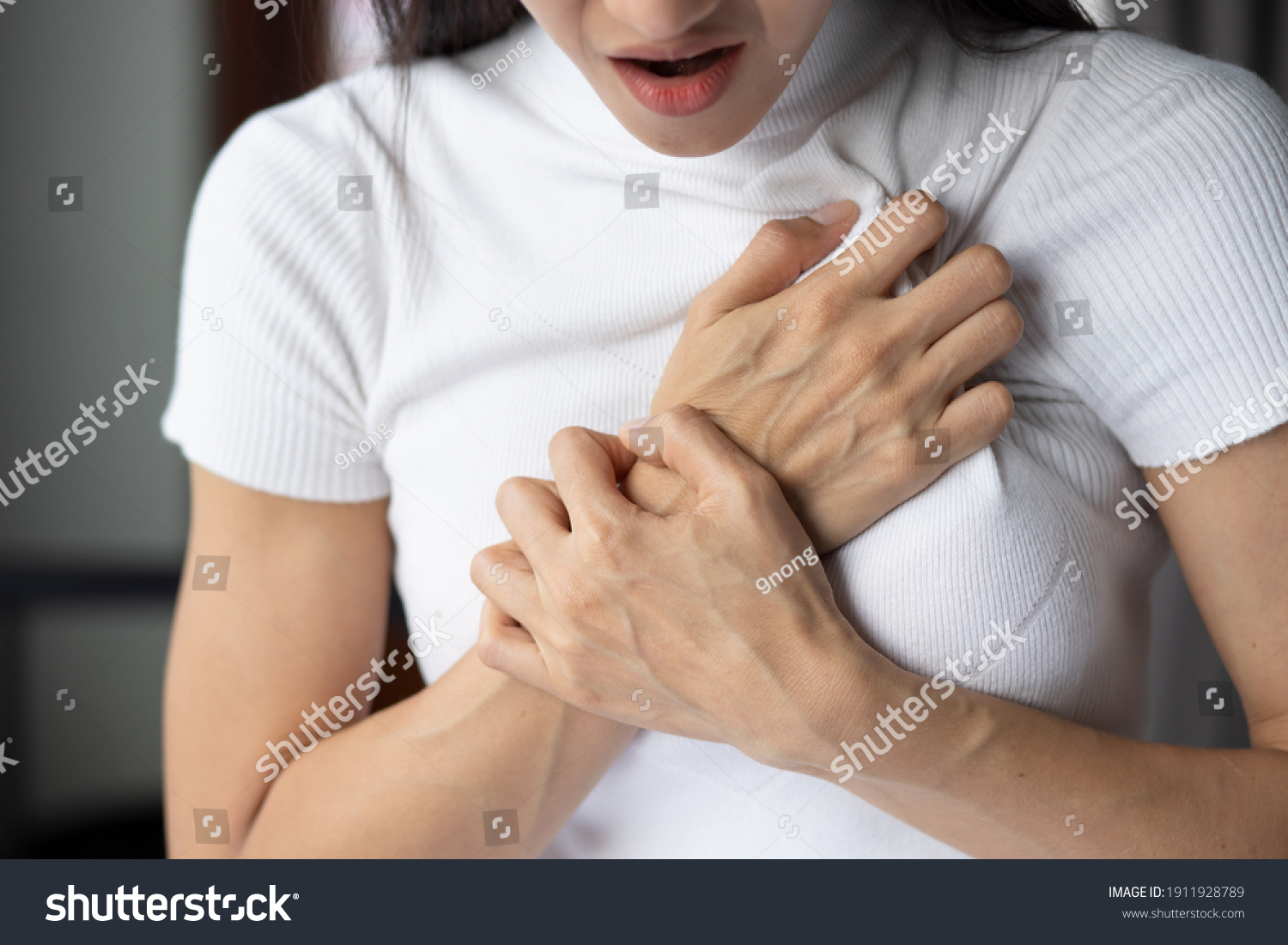 woman with sudden heart attack, sick woman suffering from acute heart attack, concept of emergency health care, asian young adult woman model #1911928789