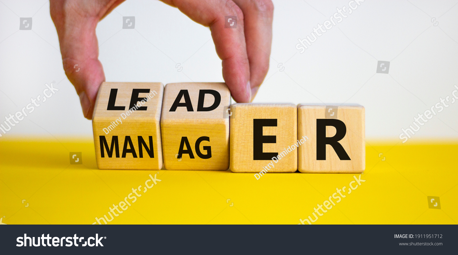 Manager versus leader symbol. Businessman flips wooden cubes and changes the word 'manager' to 'leader'. Beautiful white background, copy space. Business and manager versus leader concept. #1911951712