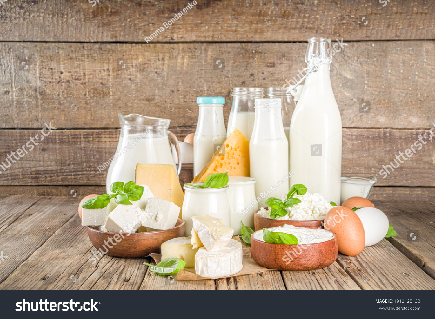 Set of Various Fresh Dairy Products - milk, cottage cheese, cheese, eggs, yogurt, sour cream, butter on wooden background #1912125133