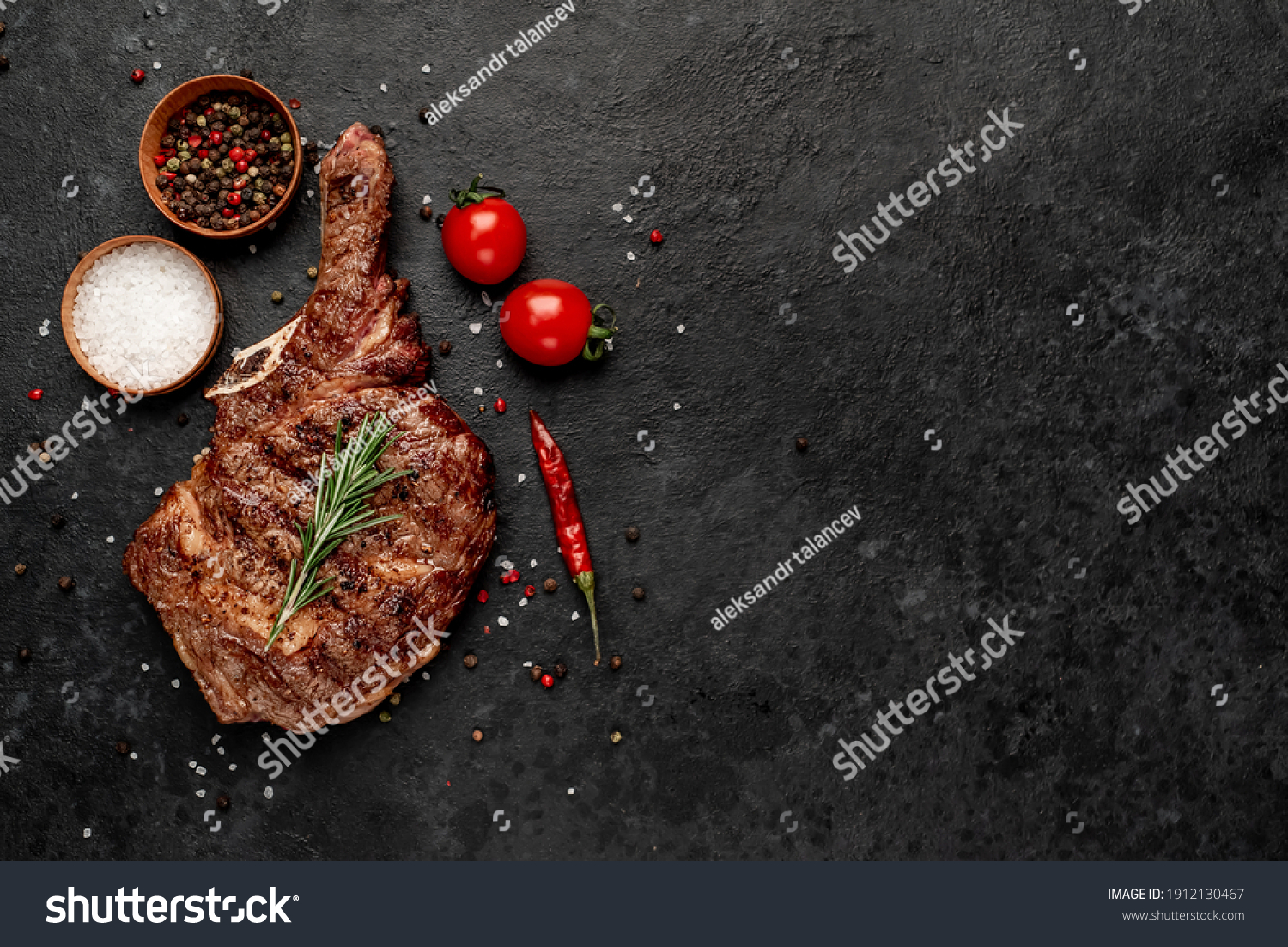 grilled cowboy steak with spices  on a stone background with copy space for your text #1912130467