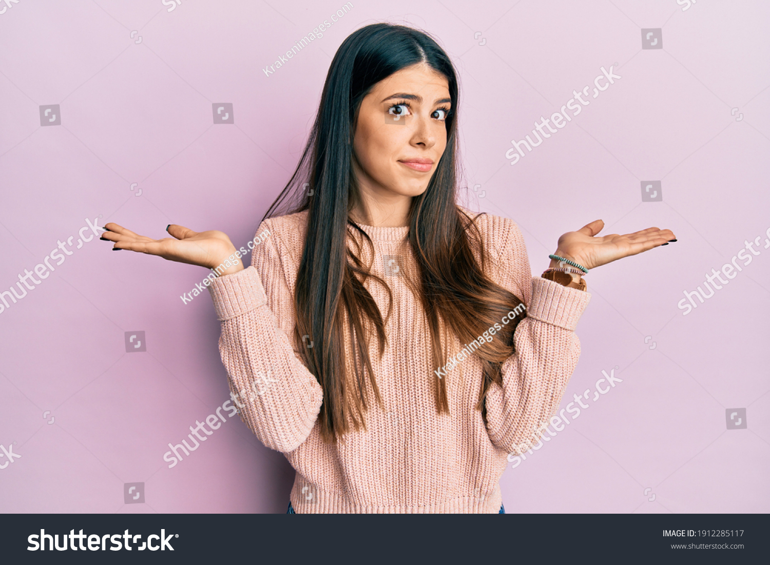 Young hispanic woman wearing casual clothes clueless and confused with open arms, no idea and doubtful face.  #1912285117