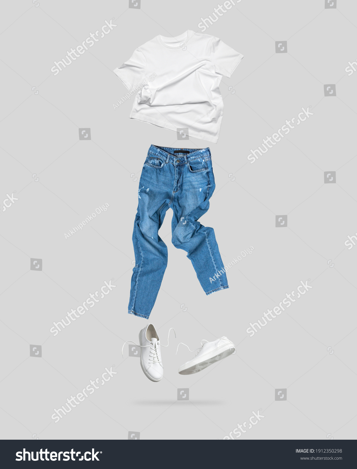 White flying cotton T-shirt, blue jeans, white leather sneakers isolated on gray background. Clean white Unisex T-shirt. Branding clothes. Mock up for your design. Spring Summer Women's Clothing #1912350298