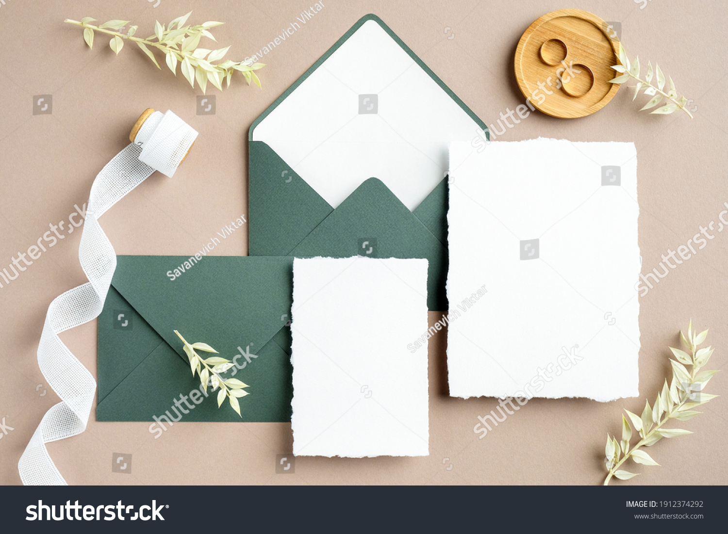 Elegant wedding stationery set. Wedding invitation cards templates, green envelopes, silk ribbon, golden rings on pastel beige background. Flat lay, top view, copy space. #1912374292