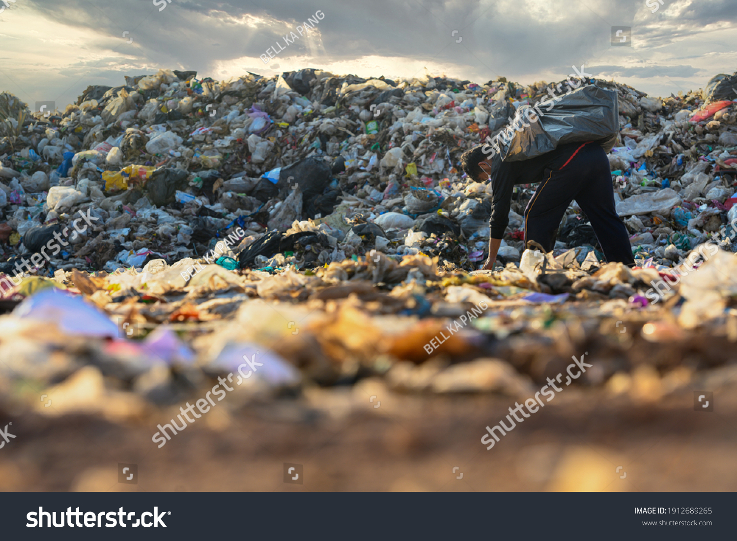 Poor people collect garbage for sale People living in garbage heaps walking to collect recyclable waste to be sold to poverty concept world environment day #1912689265