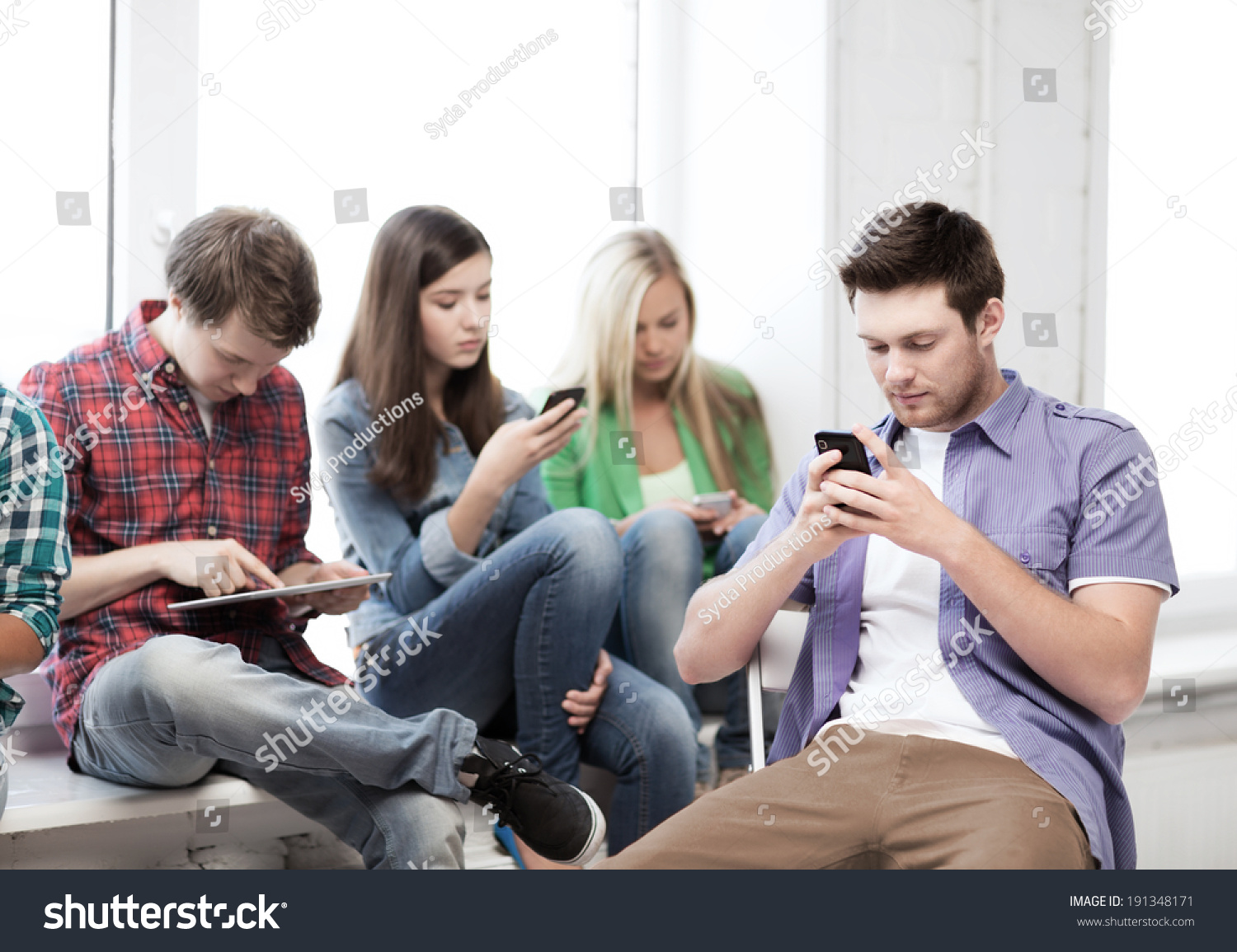 education and internet concept - students looking into phones and tablet pc #191348171