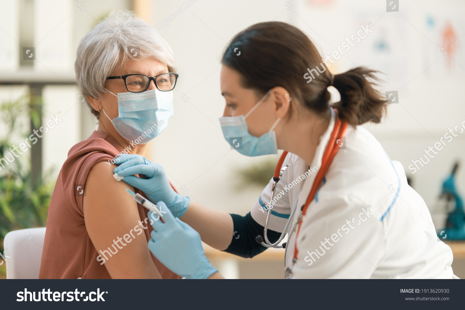 Doctor vaccinating a senior woman. Virus protection. COVID-2019. #1913620930