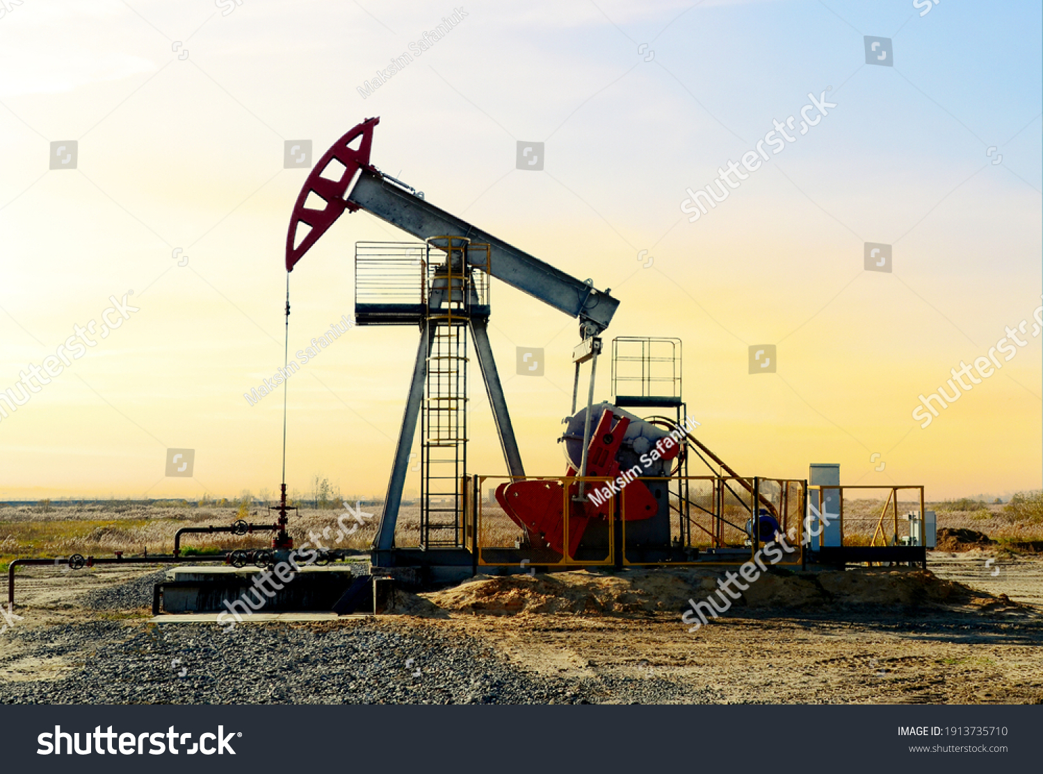 Crude oil pump jack at oilfield on sunset backround. Fossil crude output and fuels oil production. Oil drill rig and drilling derrick. Global crude oil Prices, energy, petroleum demand #1913735710