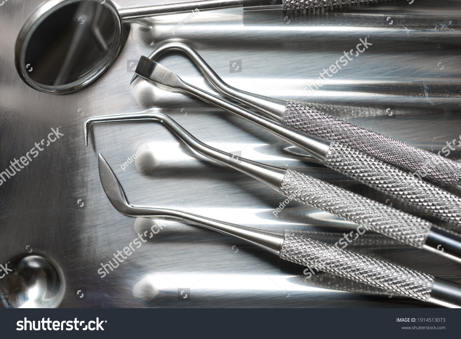 Instruments used by the dentist on a metal tray. #1914513073