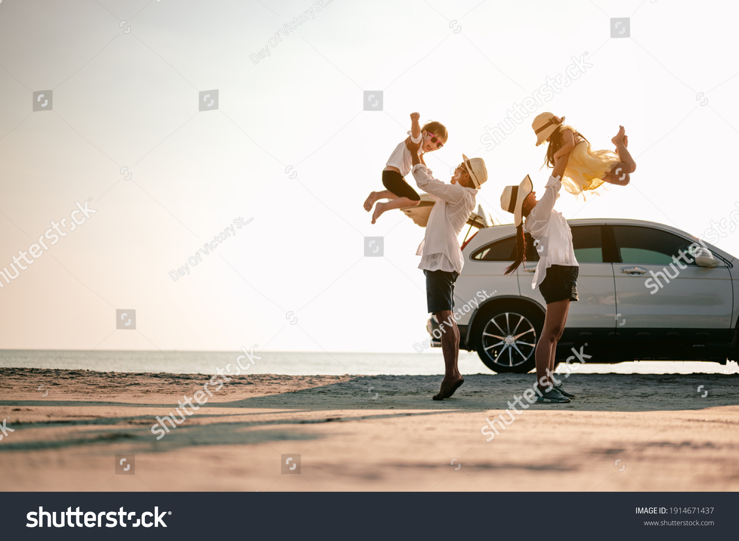 Family vacation holiday,Happy family, parents holding children flying in the sky.Concept family and Holiday and travel. #1914671437