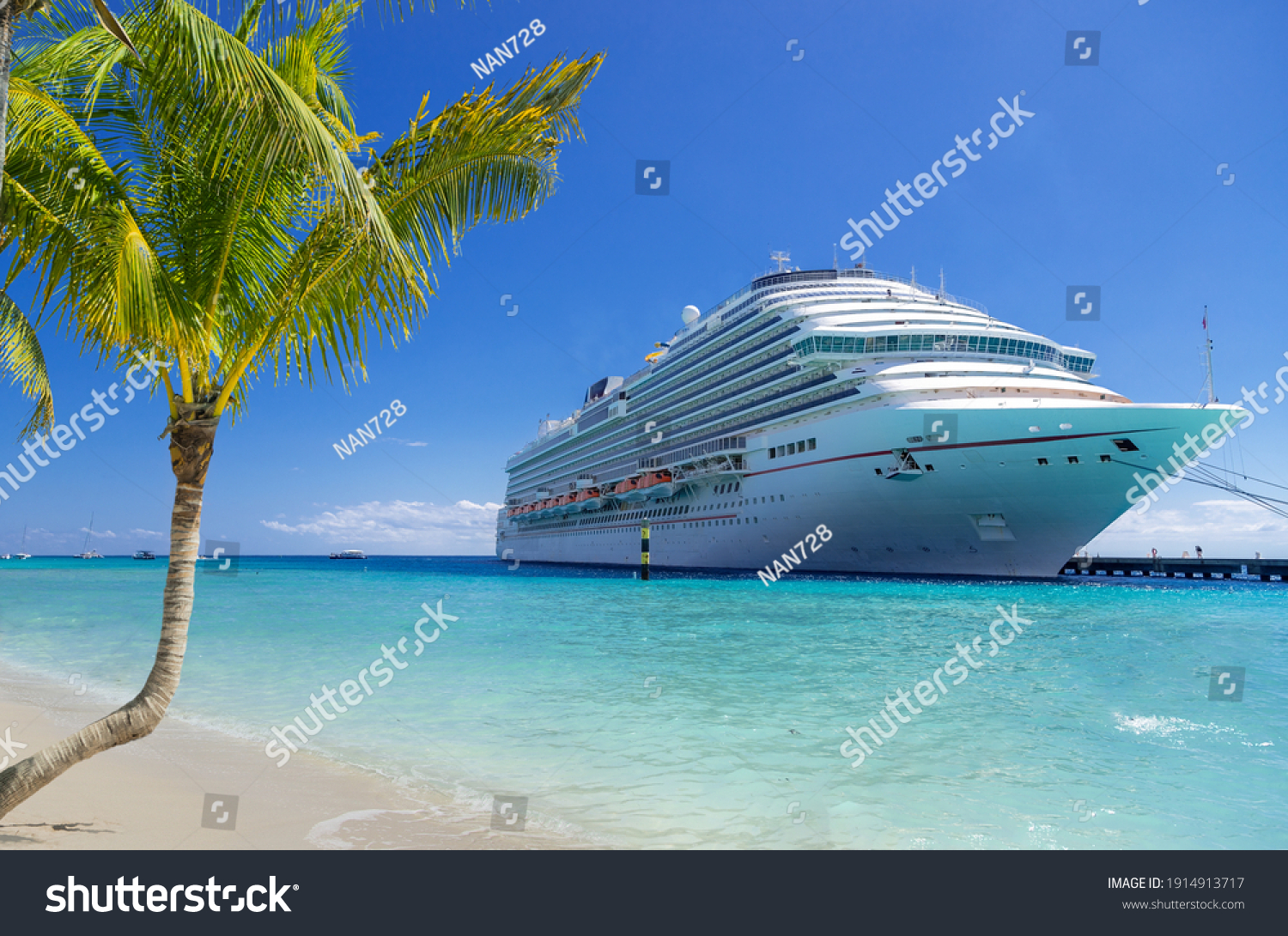 Cruise ship docked at tropical port on sunny day #1914913717
