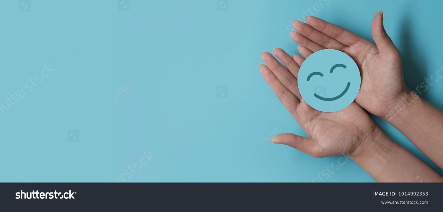 Hand holding paper cut smile face, positive thinking, mental health assessment , world mental health day concept #1914992353