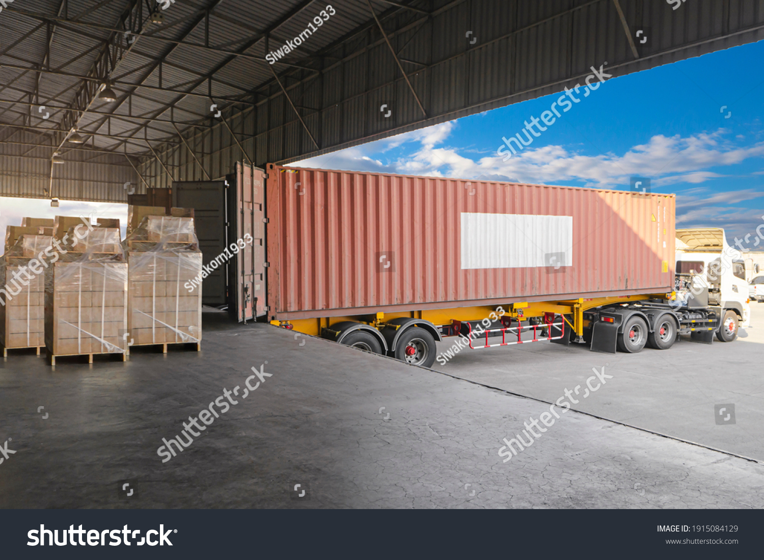 Industry Cargo Freight Trucks Transport and Logistics. Trailer Container Truck Parked Loading Package Boxes at the Warehouse. Supply Chain. Distribution Warehouse Center. Shipping Shipment Cargo. #1915084129