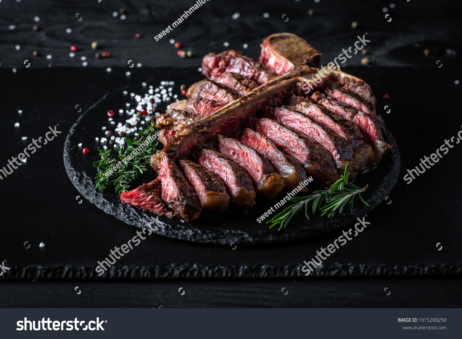 Barbecue Wagu T-Bone Steak. porterhouse grilled beef steak Medium rare with spices on a black table, banner, catering menu recipe place for text, top view. American meat restaurant. #1915200250