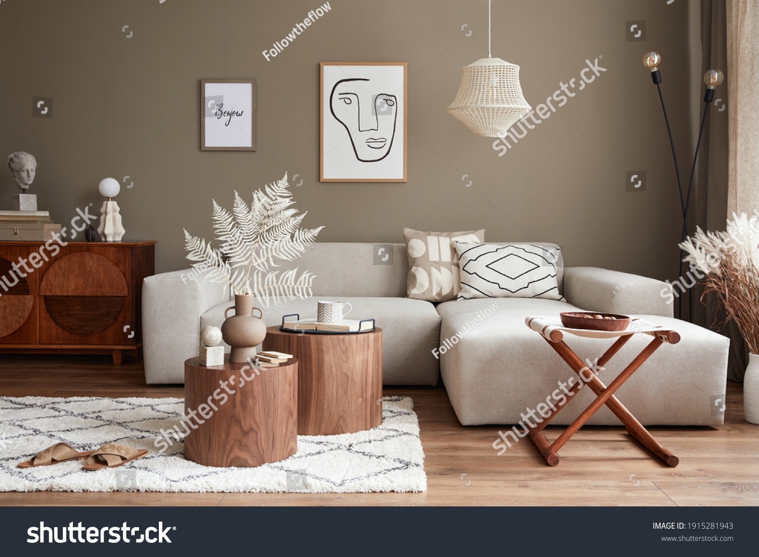 Interior design of stylish living room with modern neutral sofa, furniture, mock up poster farmes, dried flowers in vase, coffee tables, decoration and elegant personal accessories in home decor.  #1915281943