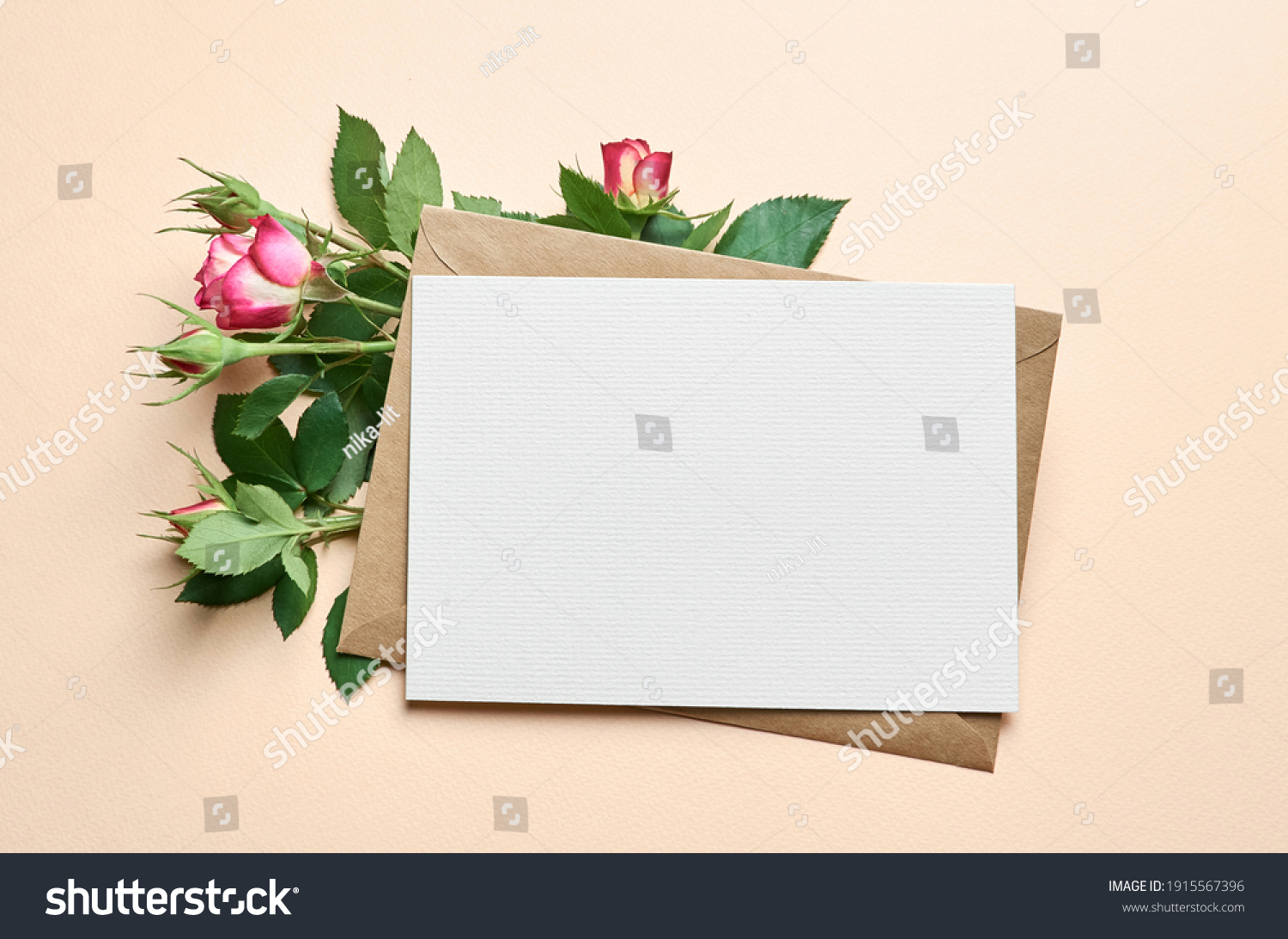 Greeting card with fresh roses flowers frame on paper background, card mockup with copy space #1915567396