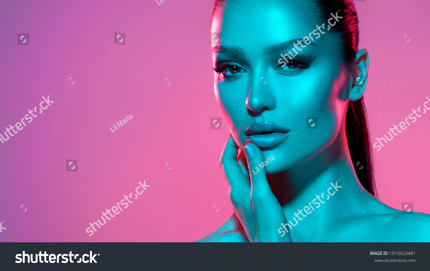 High fashion model metal silver lips and face woman in colorful bright neon UV blue and purple lights, posing in studio, beautiful girl, glowing makeup, colorful makeup. Glitter Bright Neon Makeup #1915623481