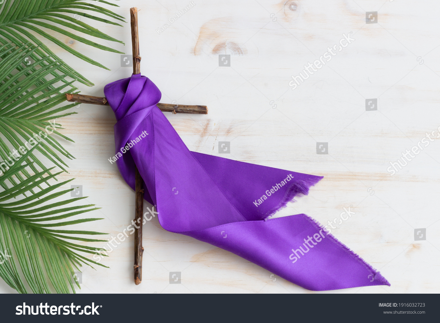 cross with purple sash and palms on white wood #1916032723