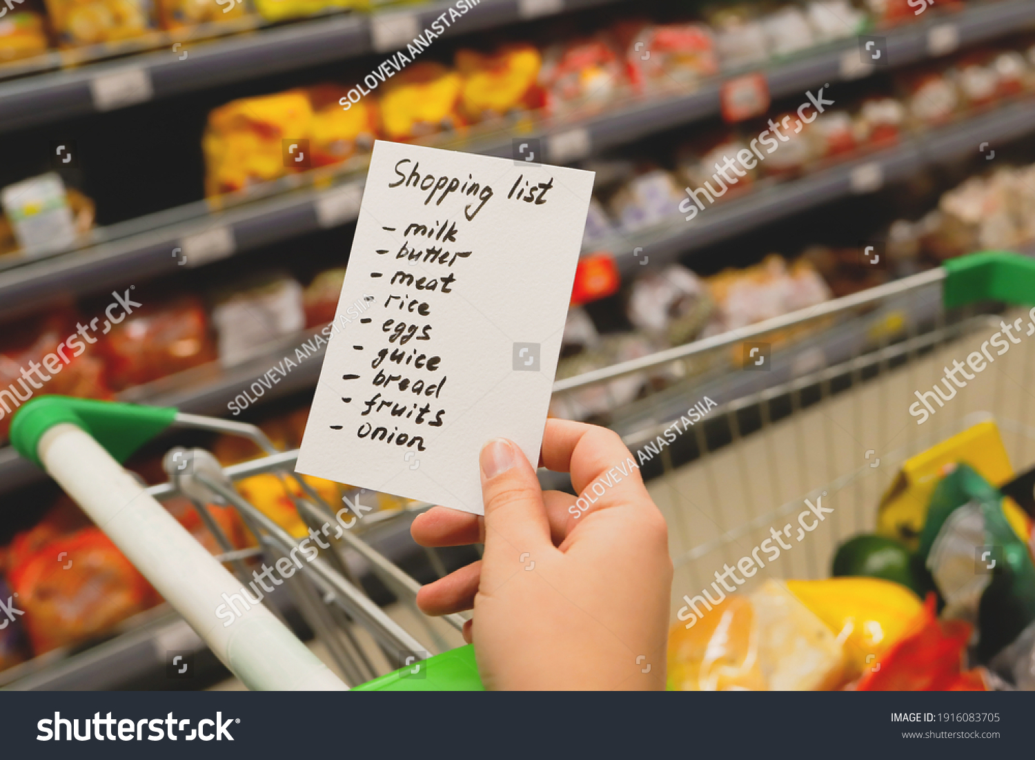 Woman with notebook in grocery store, closeup. Shopping list on paper. Check purchases in grocery cart. #1916083705