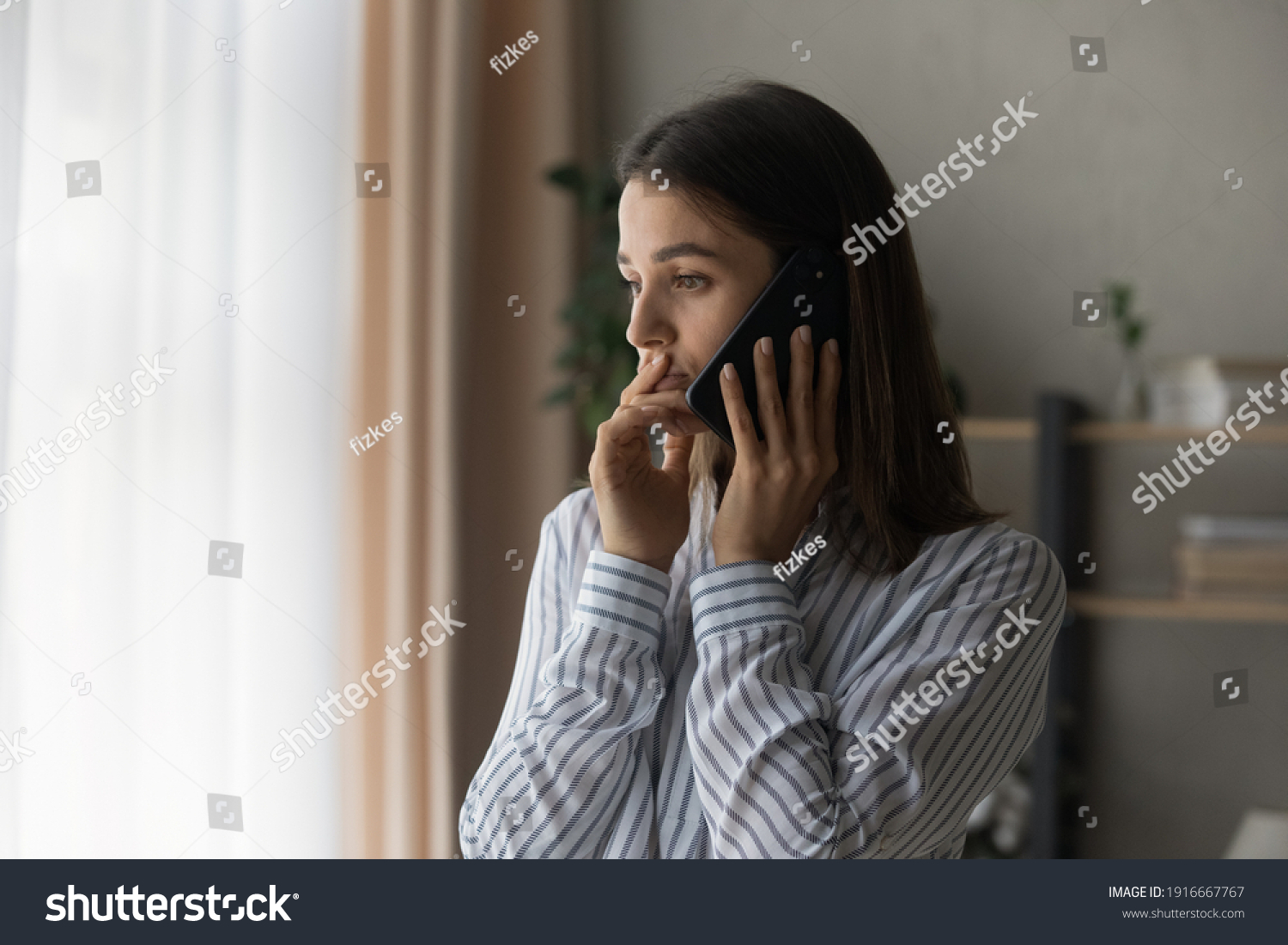 Sad millennial woman has difficult phone talk hold gadget by ear listen to unexpected bad news think on answer. Compassionate young lady support friend by cell try to help ponder on advice. Copy space #1916667767