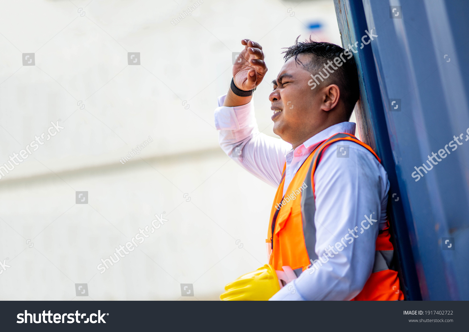 Factory worker man working in hot weather and he look tired from work. #1917402722