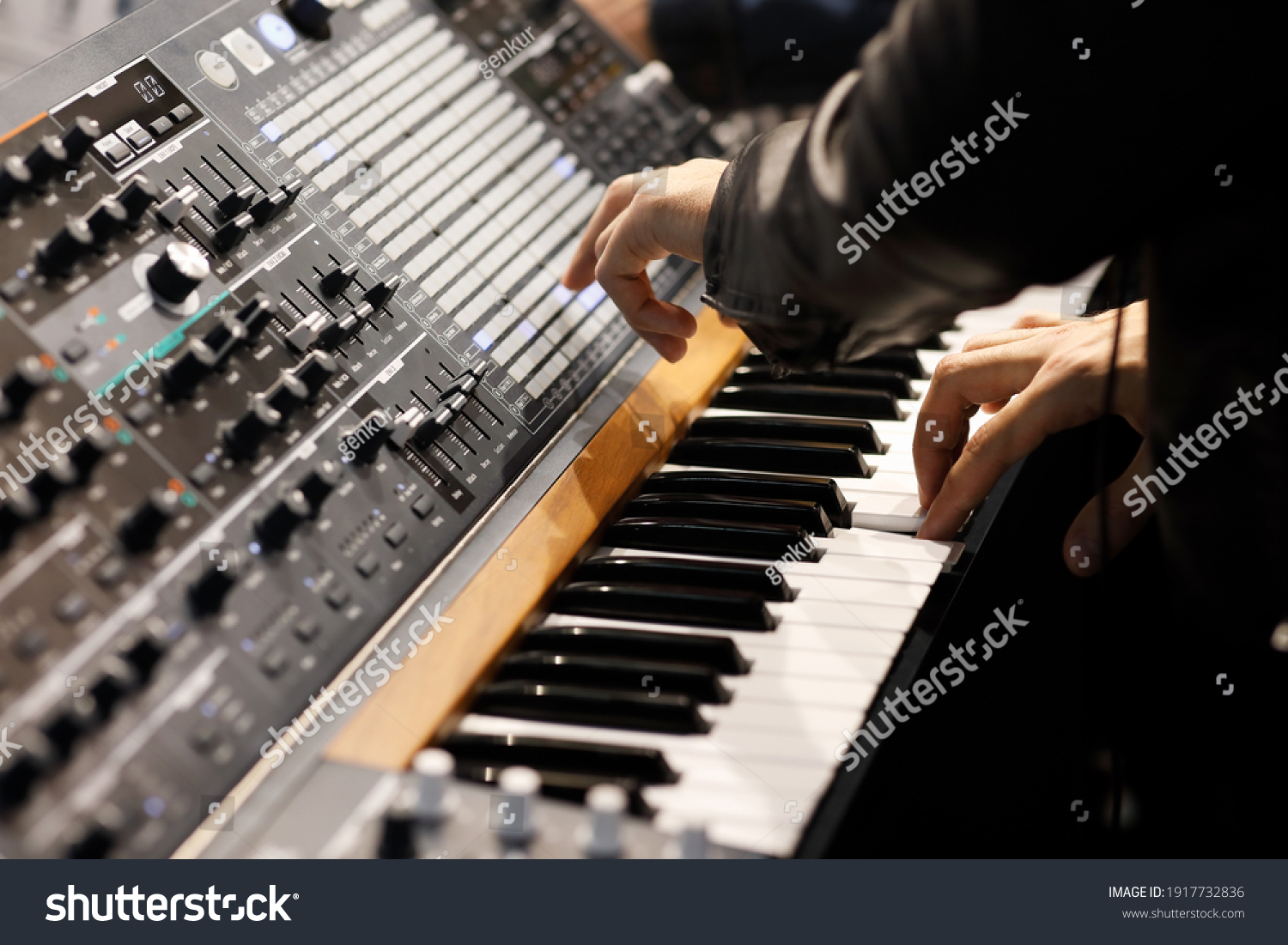 Playing music on the keyboard of a modern analog synthesizer. Selective focus. #1917732836