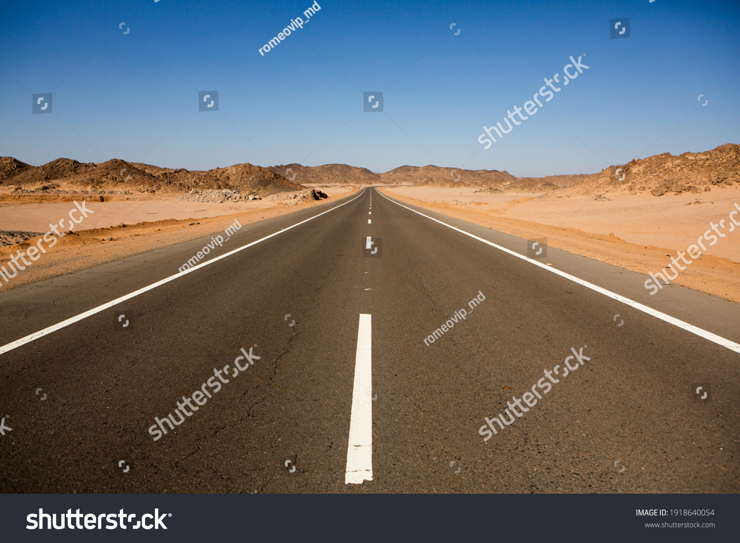 Road in the sahara desert of Egypt. Conceptual for freedom, enjoying the journey. Empty road. Freeway, Highway through the desert #1918640054