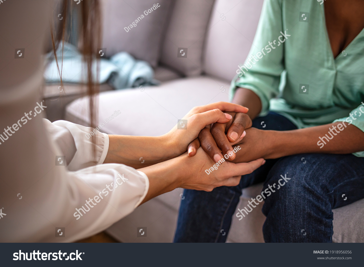 African psychologist hold hands of girl patient, close up. Teenage overcome break up, unrequited love. Abortion decision. Psychological therapy, survive personal crisis, individual counselling concept #1918956056