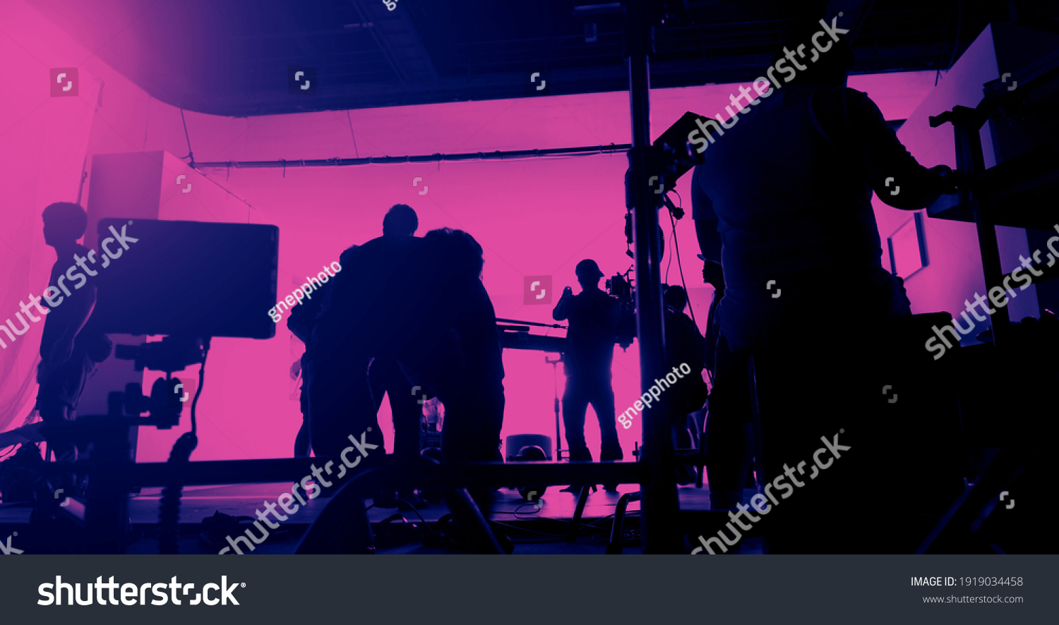 Behind the scenes of shooting video production and lighting set for filming movie which film crew team working in silhouette and professional equipment in studio for video. video production concept. #1919034458