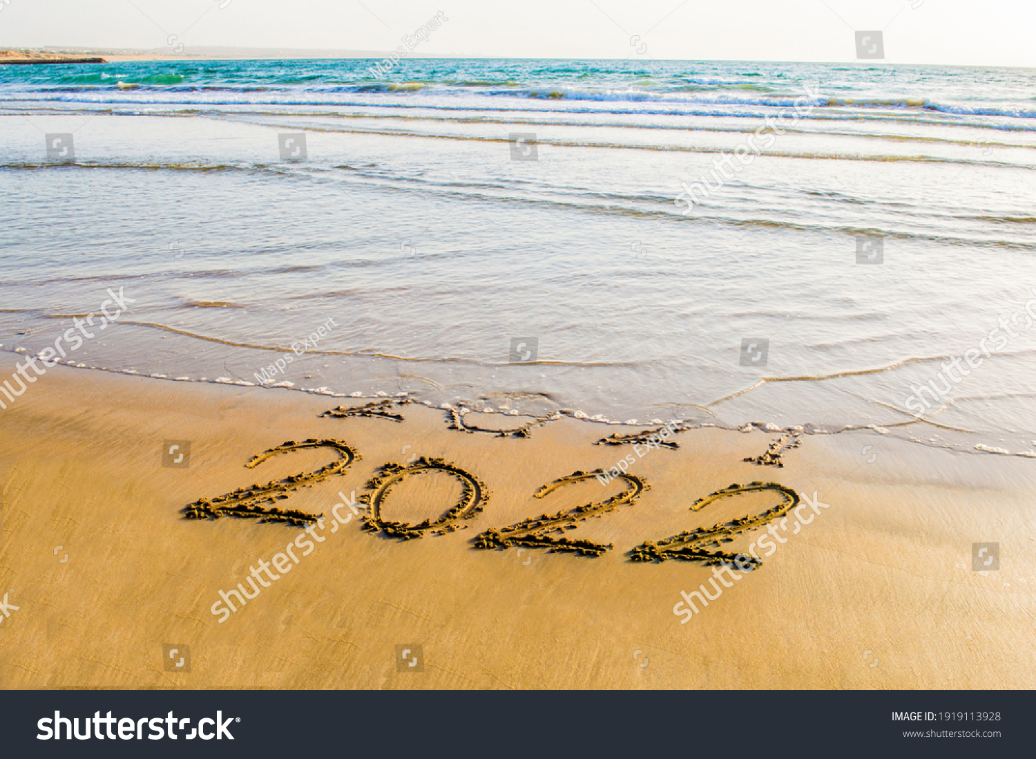 Happy New Year 2022 text on the sea beach. Abstract background photo of coming New Year 2022 and leaving year of 2021 #1919113928
