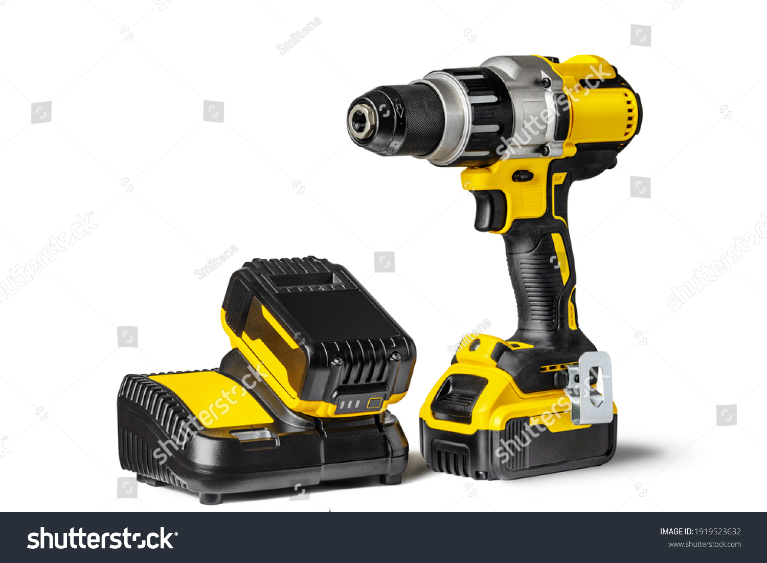 Yellow-black cordless Combi Drill Driver Hammer Drill and extra battery with charger isolated on white background. #1919523632