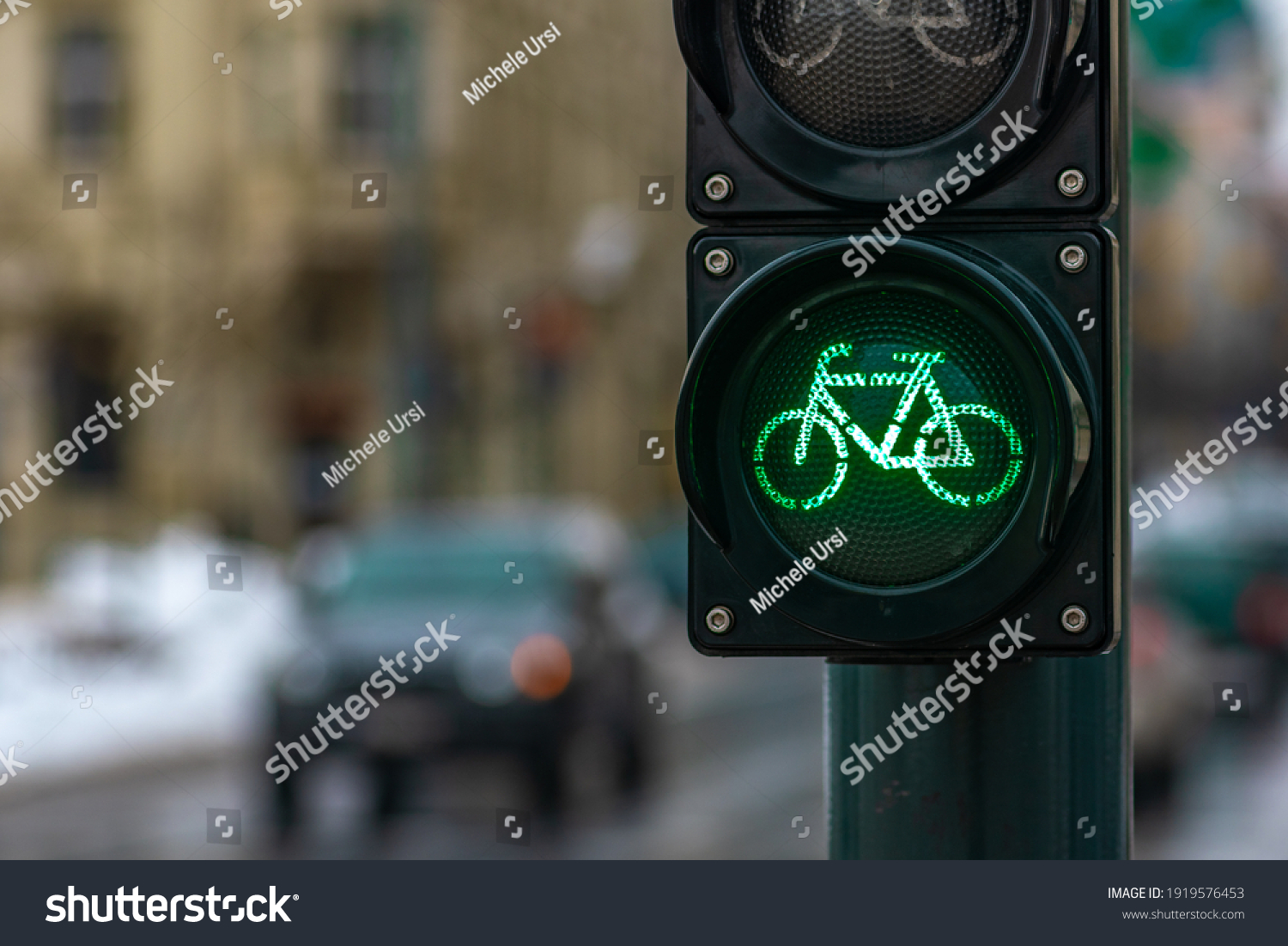 Sustainable transport. Bicycle traffic signal, green light, road bike, free bike zone or area, bike sharing, close up with street and car on background #1919576453