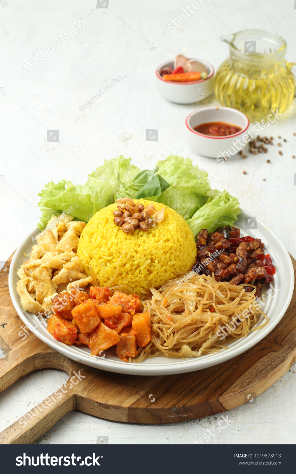 Nasi kuning or Nasi kuning is a popular breakfast in Indonesia served with vermicelli, eggs and chili sauce, it tastes delicious #1919878913