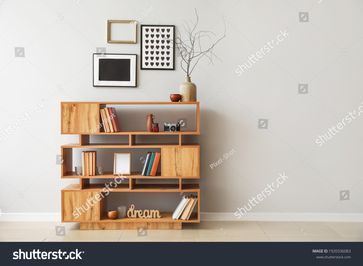 Shelving unit with books and decor in interior of room #1920336083