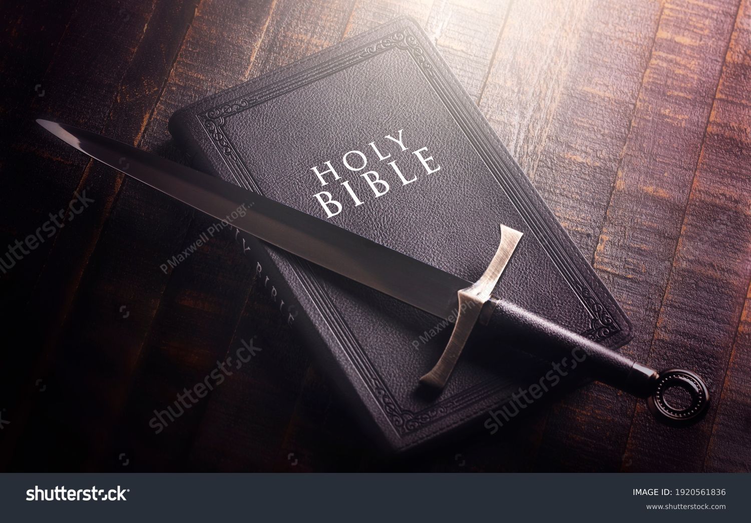 Bible and a Sword on a Dark Wooden Table #1920561836